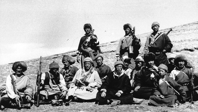 His Holiness the Dalai Lama with some of the resistance fighters and Lord Chamberlain Phala Thupten Woyten (his right) and his younger brother Tenzin Choegyal (his left) during the escape, 1959