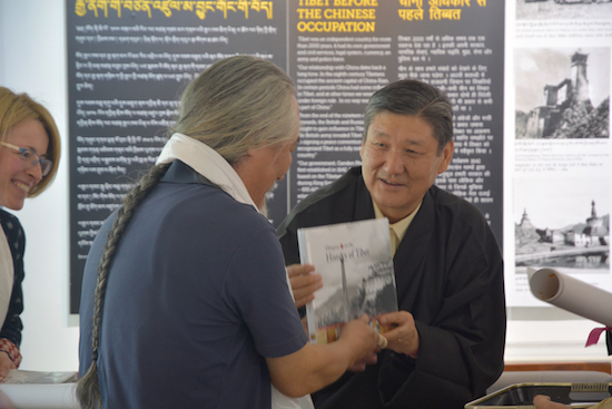 Secretary Sonam Norbu Dagpo presenting a book to thank Mr Tashi Tsering for his artistic contributions towards the exhibition.