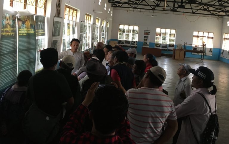 Museum staff, Tenzin Ramjam explaining the exhibits to visitors.