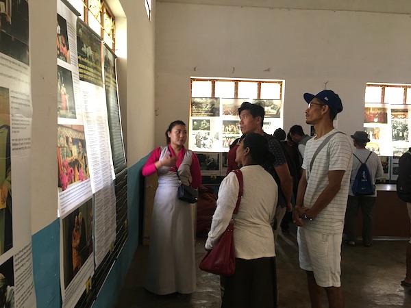 Museum staff, Tenzin Ingsel explaining the exhibits to visitors.